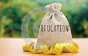 Money bag with the word Education. The concept of saving money for studies. Investments of budgetary funds in the educational