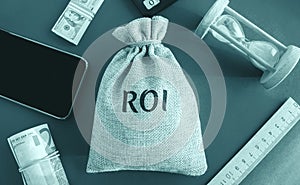 Money bag with the word Roi. Return on investment concept. Profitability and loss-making of investments. ROMI  Return On