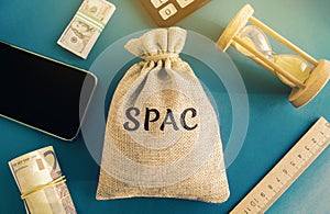 Money bag with the word SPAC - Special purpose acquisition company. Simplified listing of company, merger bypassing stock exchange photo