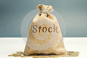 Money bag with the word Stock and coins. Trading on the stock exchange. Investment portfolio. Capital gains. Common and preferred photo