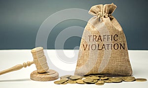 Money bag with the word Traffic violation and the judge`s hammer. Law. Court. Fine, legal fees. Traffic Tickets. Speeding. Failur