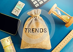 Money bag with the word Trends. Popular and relevant topics. New ideological trends. Recent and latest trend. Evaluation methods. photo