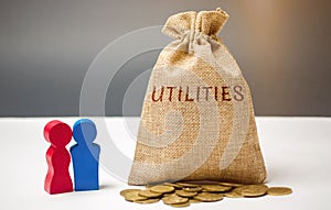 A money bag with the word Utilities and a family. The concept of saving money for the payment of utilities. The accumulation of