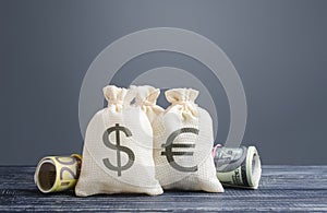 Money bags and world currencies. Capital investment, savings. Economics, lending business. Profit income, dividends payouts.