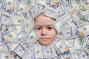 Money banknotes, cash dollars bills. Funny face in lot of money. Fun kid face on dollars money.