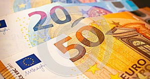 Money bills background. Euro - EUR. Euro banknotes on a table in close-up photography.