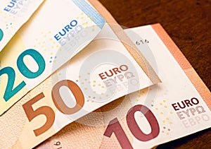 Money bills background. Euro - EUR. Small fan-shaped euro banknotes on a table in close-up photography.