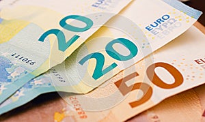 Money bills background. Euro - EUR. Small fan-shaped euro banknotes on a table in close-up photography.