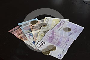 Money bills and euro coins on a table photo