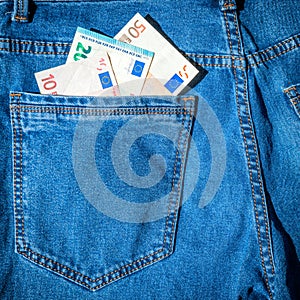 Money in blue jeans pocket