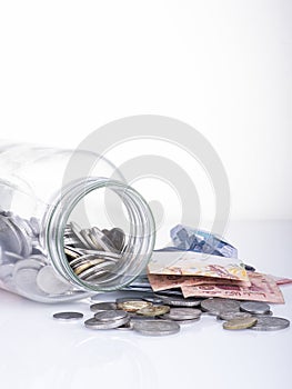 Money and bottle over white background