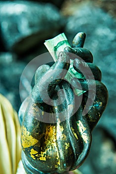 Money in Buddha Hand