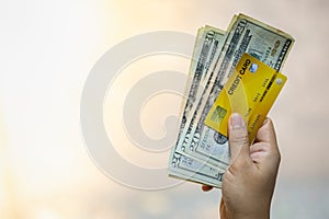 Money and Business concept. Close up of woman hand holding credit card and 20 US dollars banknote with copy space