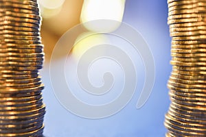 Money, Business Concept. Closeup of two stack of gold coins on blue background with copy space