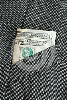 Money in a business suit pocket