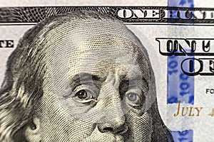 Money, busyness and finances concept. One hundred dollar bill detail with president Franklin portrait close-up. American national