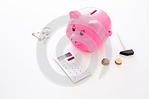 Money for buy car. Moneybox in shape of pig near keychain in shape of car, coins, calculator on white background copy