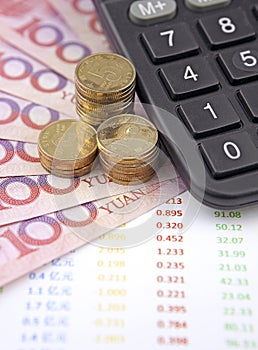 Money and calculator with charts on desk