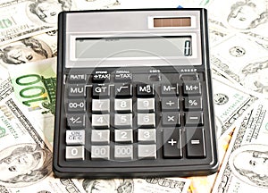 Money and calculator over white