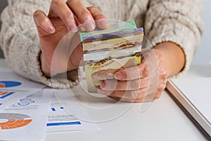 Money from Canada. Dollars. Person handling papernotes on desk