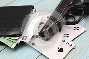 Money cards and gun on black background