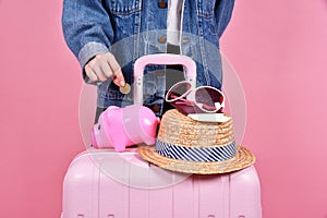 Money cash saving for travel concept, Traveler and pink suitcase.