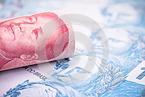 Money from china and brazil, banknotes of one hundred reais and banknotes of 100 yuan, or Renminbi. Brazil and china market