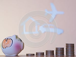 Money coin stack with paper cut of a home, plane, car background, Saving money concept.