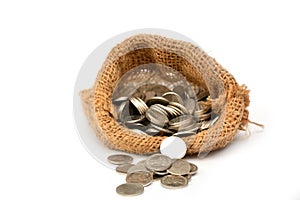 Money coins in bag isolated on white.