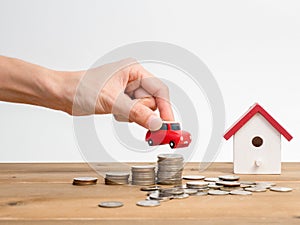 Money coins stack growing with red house on wood background. Business growth investment and financial concept ideas.Real estate in