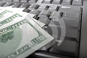 Money on computer keyboard