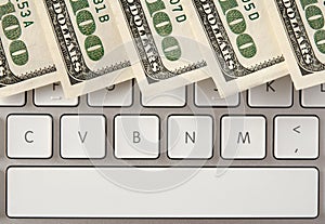 Money on computer keyboard with spacebar photo
