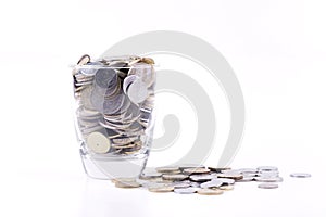 Money concept, coins inside or with the glass isolated over whit