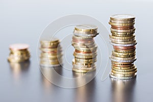 Money concept: Coins tacked on each other. Inflation, currency, savings, money photo