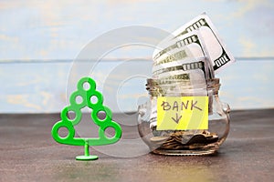 Money concept, transparent glass with dollar banknote on a wooden table. tree is a profit symbol, there is toning. shallow depth