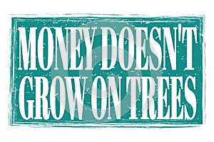 MONEY DOESN`T GROW ON TREES, words on blue grungy stamp sign photo
