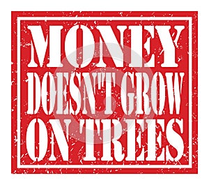MONEY DOESN`T GROW ON TREES, text written on red stamp sign photo