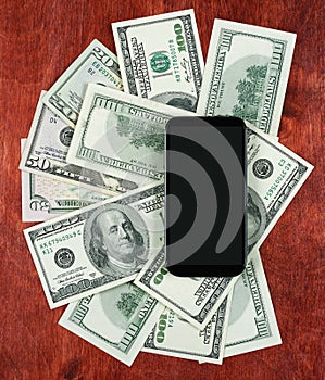 Money dollar currency and smartphone on wood background, business concept, blank space, mock up