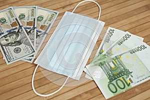 Money dollars, euro banknotes bill with face mask. Crisis and finance concept. COVID-19 coronavirus, pandemic. Mouth mask with