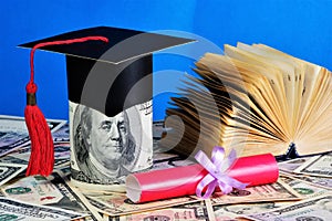 Money for education. Red diploma of the excellent student and academic cap of the student.