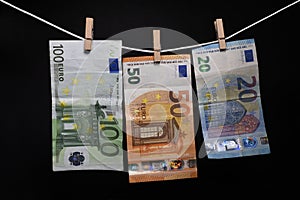 Money. Euro banknotes hanging on rope attached with clothes pins