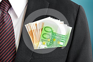 Money, Euro currency(EUR) bills, in businessman suit pocket photo