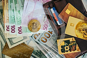Money euro dollars and bitcoin with wallet and bank cards