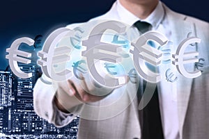 Money exchange concept. Businessman with euro currency symbols and city on background, closeup