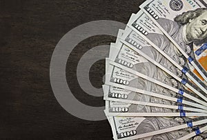 Money fan on black background. Copy space