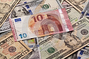 Money and finances concept. Ten euro new bill on colorful abstract background of American national currency, dollar banknotes