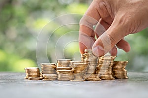 Money Financial Business Growth concept Man hand put money gold coins to stack