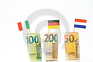 Money and flags of European countries.Flags of Germany, France and Italy euro bills on a white background.