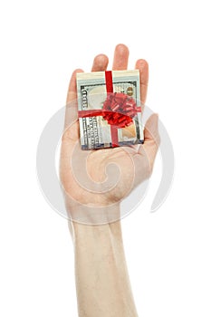 Money gift. American dollars cash with red ribbon in male hand isolated on white background. US Dollars 100 banknote