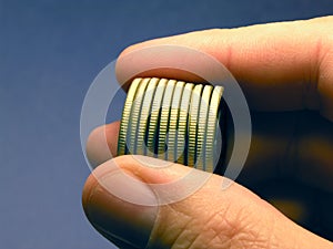 MONEY - Gold Coins held in Hand